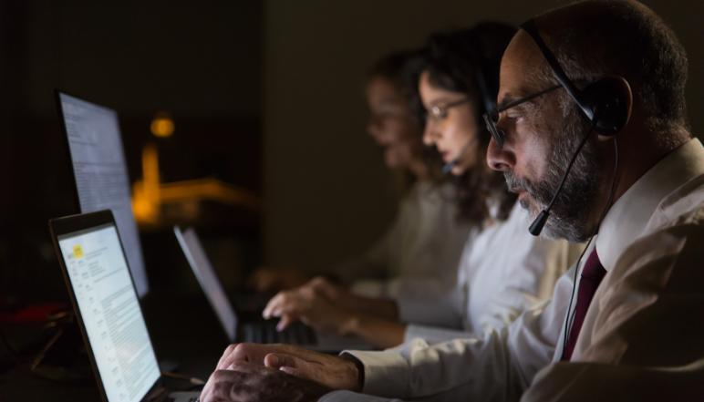 IT support technician working with network hardware and laptop illustrating outsourced IT support services.